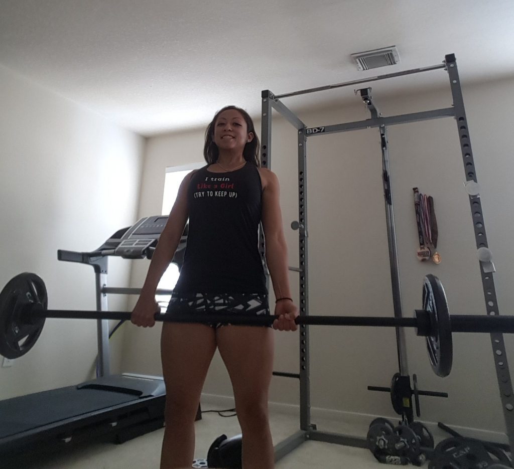 Val Airing holds the bar during deadlift