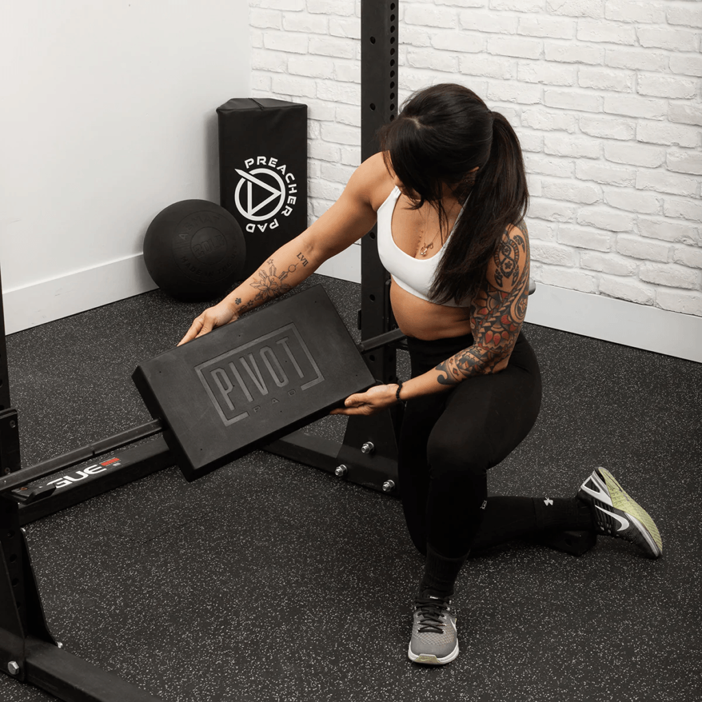 image of woman holding the AbMat Pivot pad one of three AbMat products to level up your home gym